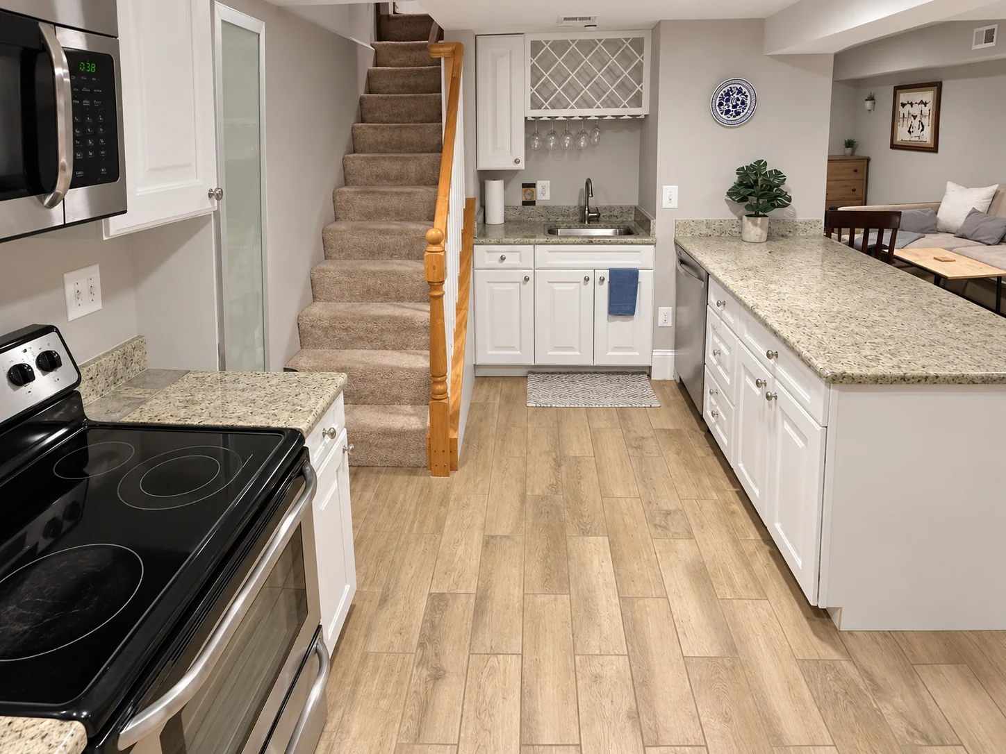 Kitchen with granite counters, appliances and adjacent stairs
